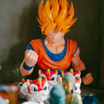 Photo by Pew Nguyen A vibrant display of anime figurines including Goku amidst various collectibles against a gray background.