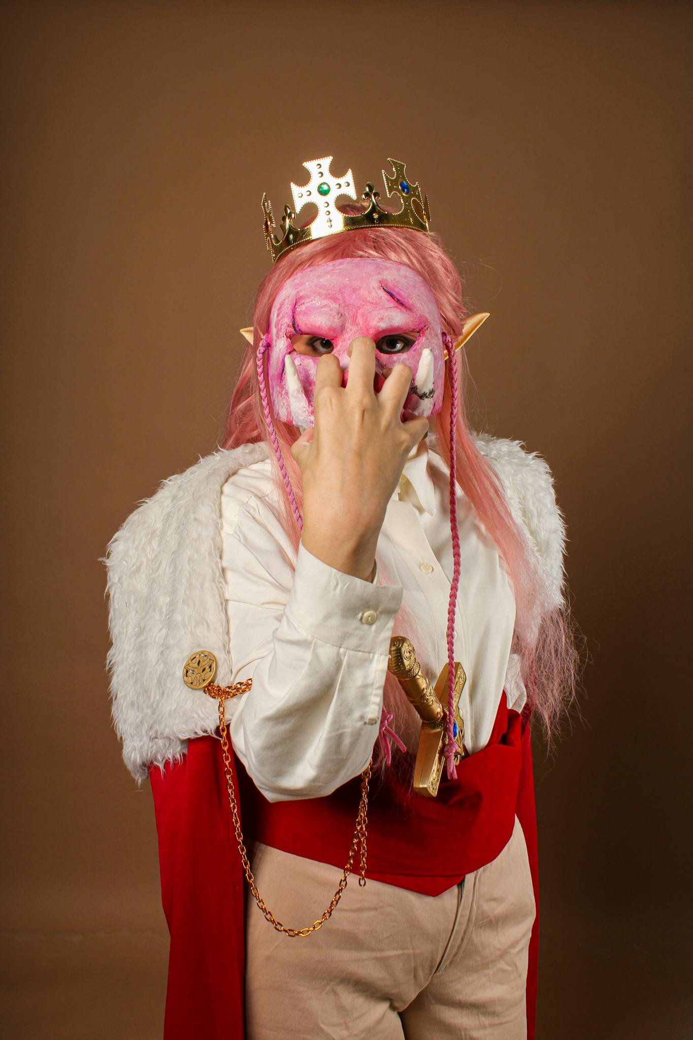 Captivating anime cosplay portrait with pink hair and regal crown.