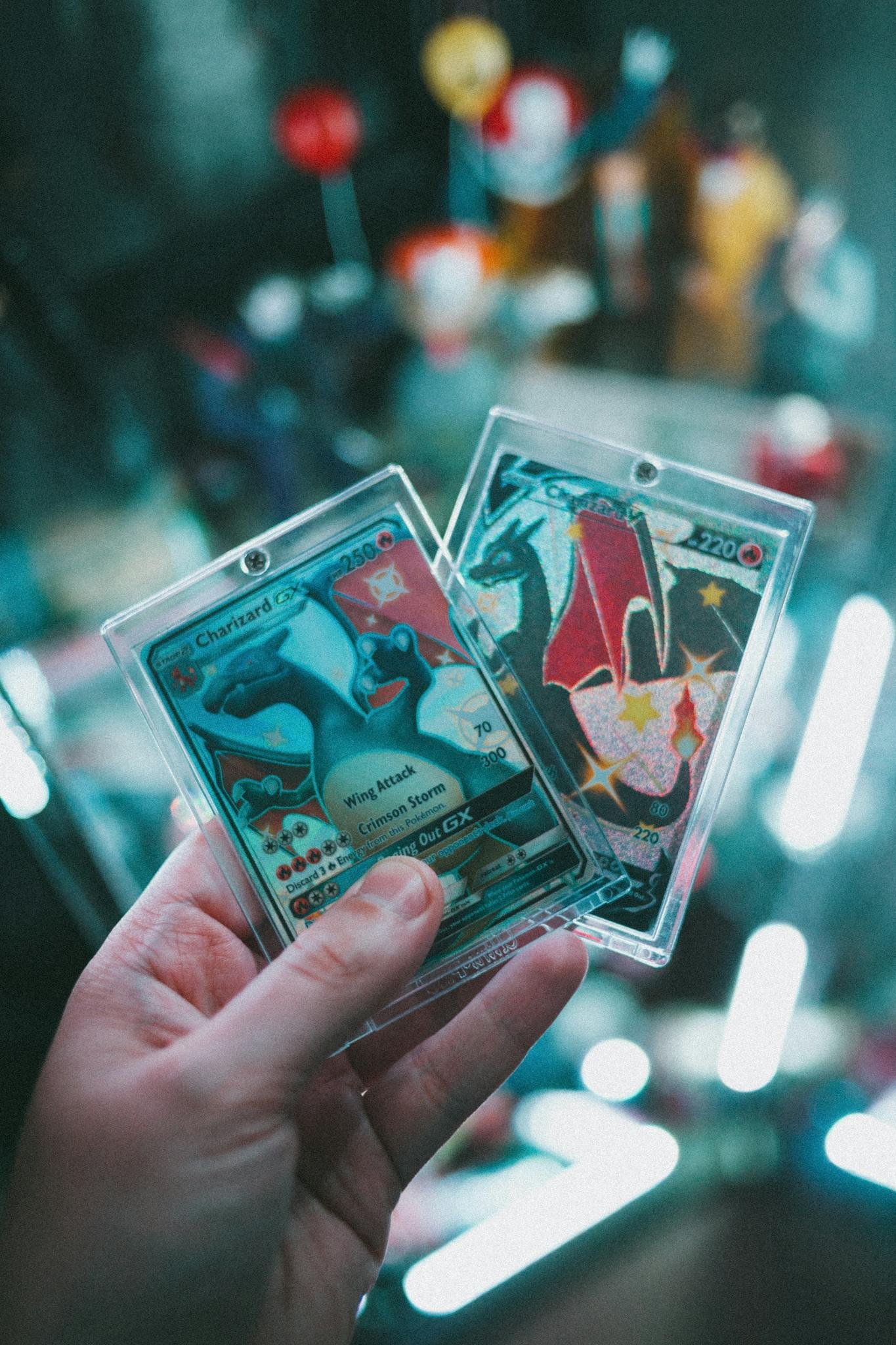 Close-up image of a hand holding colorful trading cards with a blurred background.